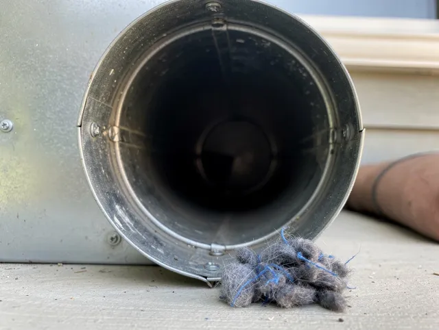 Swansea Dryer Vent Cleaning technician using specialized equipment to clear severe dryer vent blockage in Swansea